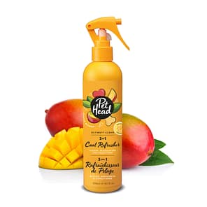 Orange Trigger spray bottle of Pet Head Ultimutt Coat refresher in front of cut and whole Mangoes