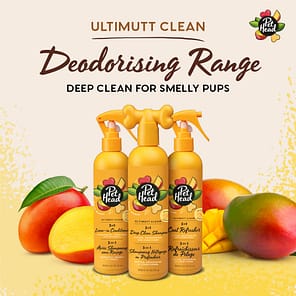 Pet Head Dog Grooming Shampoo Conditioner and Refresher Spray Range, 3 orange bottles against a background of cut and whole mangoes
