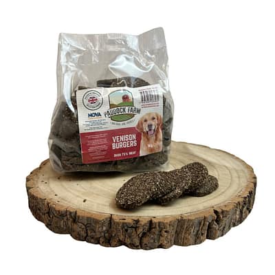 Pack of Venison Burger Dog treats displayed on a log with 4 loose burgers out of packet