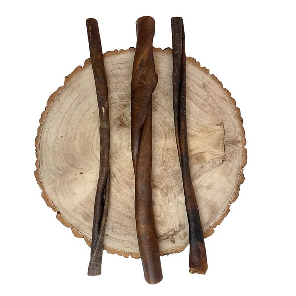 3 Rolls of Camel Skin Natural Dog Chews displayed on a log plinth