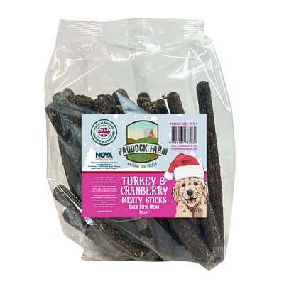 1kg pack of Turkey & Cranberry meaty stick/sausages dog treats featuring a smiling cartoon labrador on the front wearing a santa hat