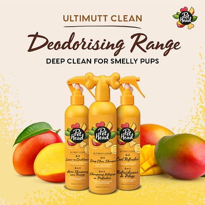 Pet Head Dog Grooming Shampoo Conditioner and Refresher Spray Range, 3 orange bottles against a background of cut and whole mangoes